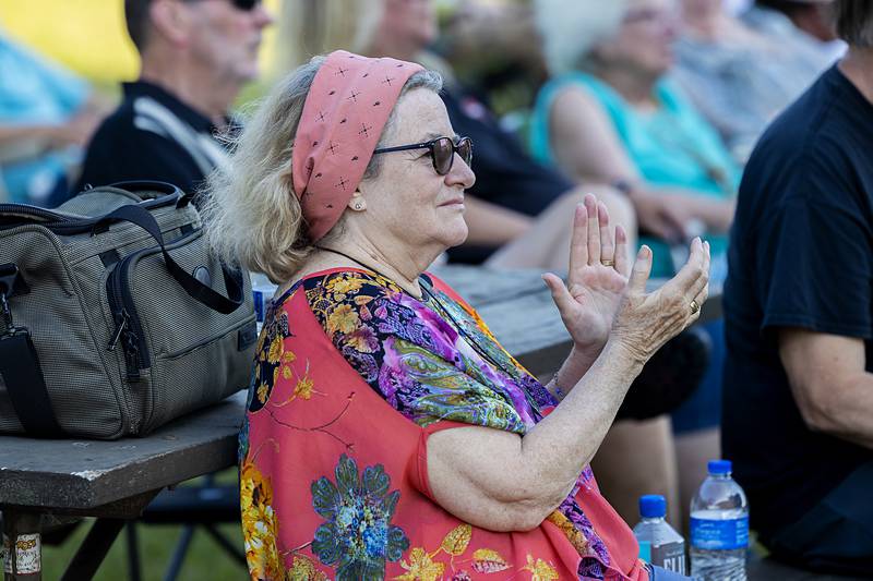 Mary Angela Brinton claps along to the music Saturday, June 22, 2024 outside of the grist mill in Franklin Creek State Park.