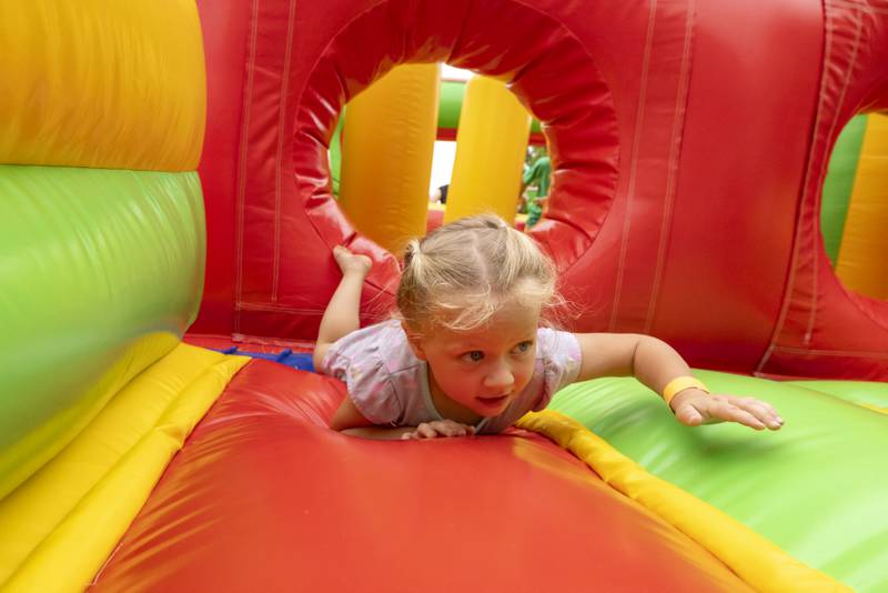 Jolie Pijanowski dives through the obstacle in the bounce house Saturday, June 8, 2024, at Buffalo Days in La Moille.