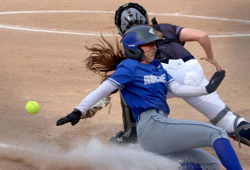 Burlington Central’s Kelsey Covey slides safely into home in varsity softball at Cary Monday.