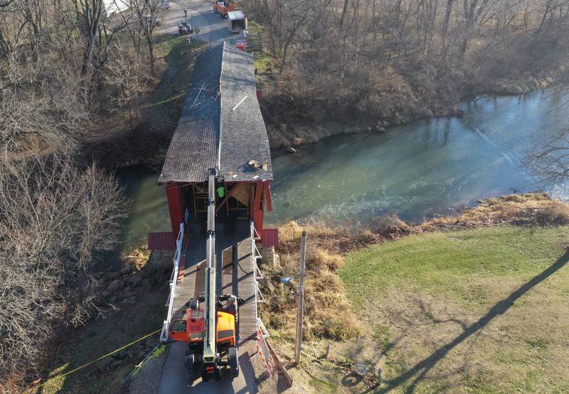 An Illinois Department of Transportation crew begins repairs on the Red Covered Bridge on Monday, Dec. 11, 2023 in Princeton. The bridge was severely damaged when it was struck by a semi truck on Nov. 16.