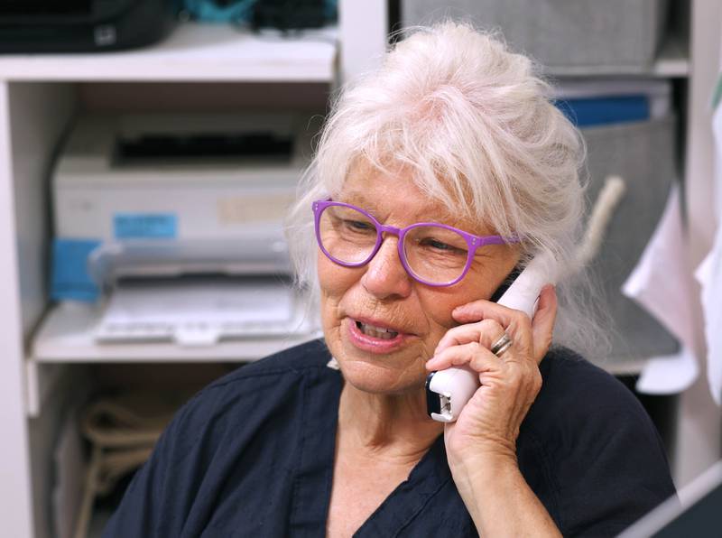 Oaken Acres Wildlife Center Founder and President Kathy Stelford, where she spends a lot of her time, answering questions on the phone for someone who found an injured animal Tuesday, June 18, 2024, at the facility in Sycamore. Oaken Acres is celebrating its 40th anniversary this year.