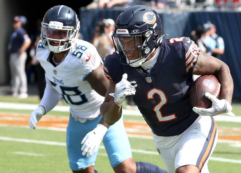 Chicago Bears wide receiver DJ Moore gets by Tennessee Titans linebacker Harold Landry III on a run play during their game Sunday, Sept. 8, 2024, at Soldier Field in Chicago.