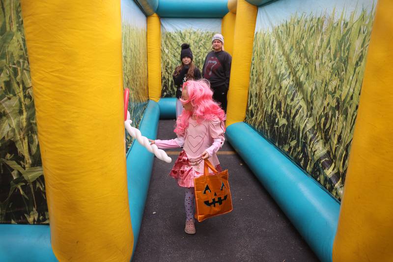 A family walks through an inflatable corn maze at the Hayride of Horrors on Monday, Oct. 14, 2024 at Dellwood Park in Lockport.