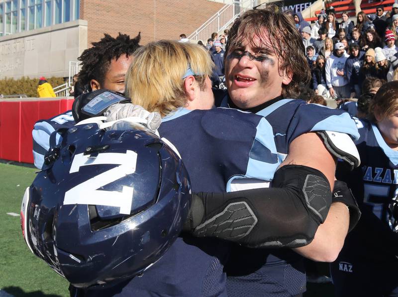 Nazareth's Gabe Kaminski celebrates with a teammate after the Roadrunners beat Joliet Catholic to win the Class 5A state championship in November 2023 at Hancock Stadium at Illinois State University in Normal.