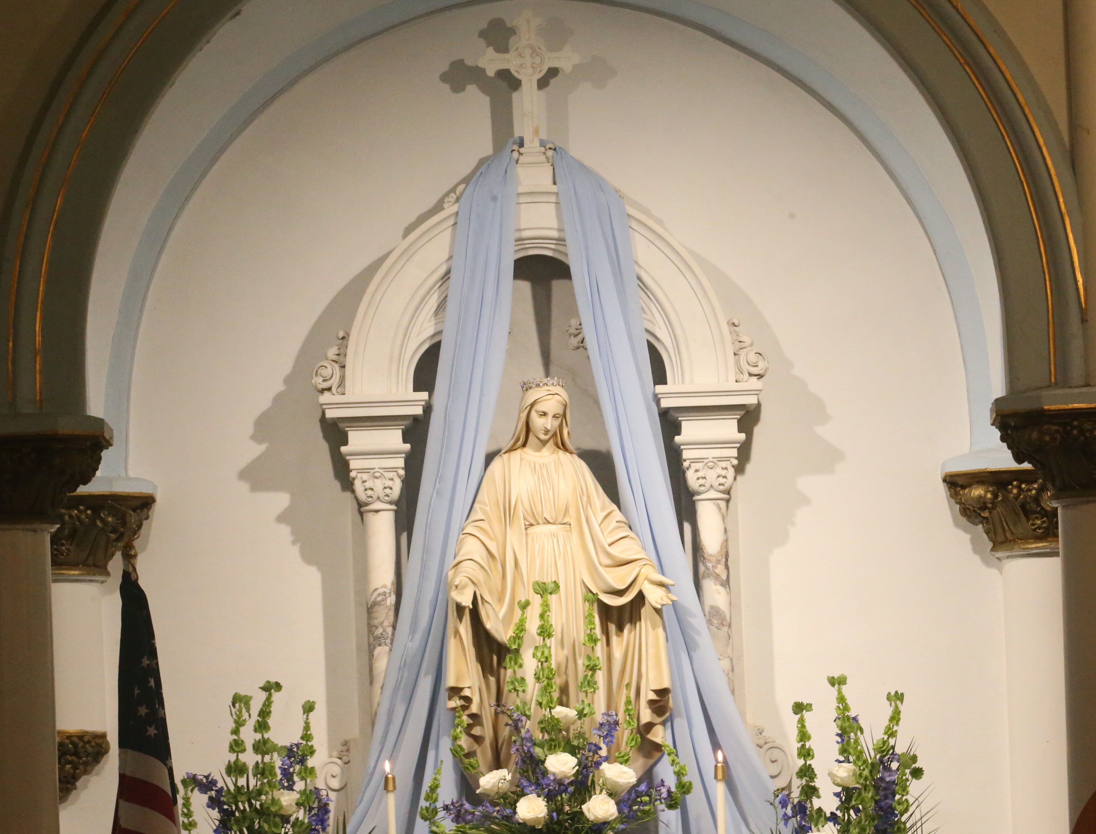 The Mother Mary statue is surrounded by flowers during the final Mass at St. Mary's Church on Thursday, Aug. 15, 2024 in Peru. The church was founded in 1867.