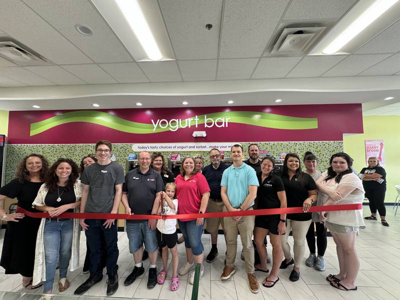 Eric, Sarah and Claire Peterson cut the ribbon officially opening Menchie’s Frozen Yogurt in Minooka during a ribbon cutting ceremony with the Channahon Minooka Chamber last month. Minooka Mayor Ric Offerman, village staff, Chamber representatives, family and friends joined the Menchie’s team for the celebration.