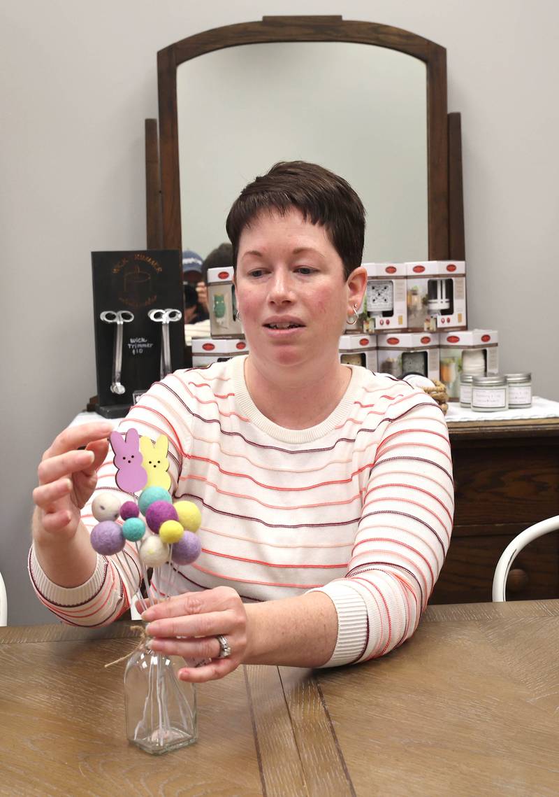 Joni Peterson, owner of 35:35 Makers Collective, talks Friday, March 18, 2022, about one of the items available for purchase in the shop. The store, at 308 West State Street in Sycamore, is scheduled to open April 1.