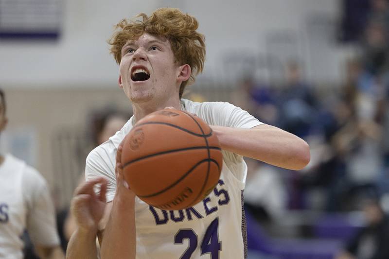 Dixon’s Austin Hicks goes hard to the hoop  Saturday, Jan. 7, 2023 in a game against McHenry.