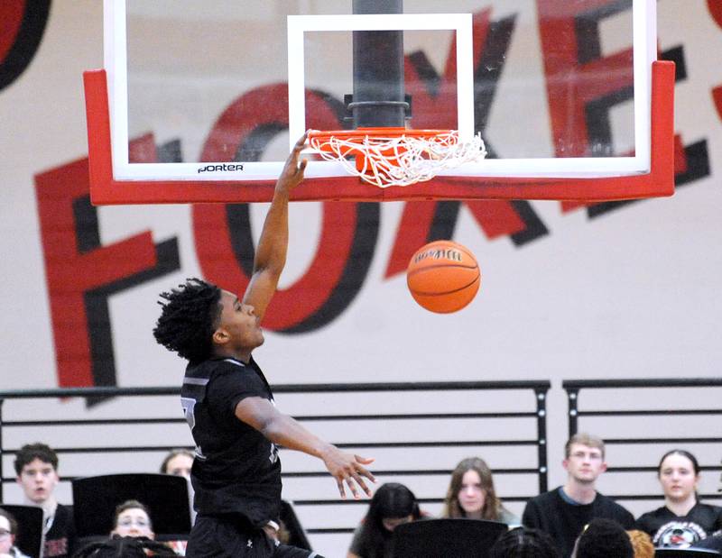 Oswego East's Jehvion Starwood slams the ball during a varsity basketball game at Yorkville High School on Friday, Feb. 9, 2024.