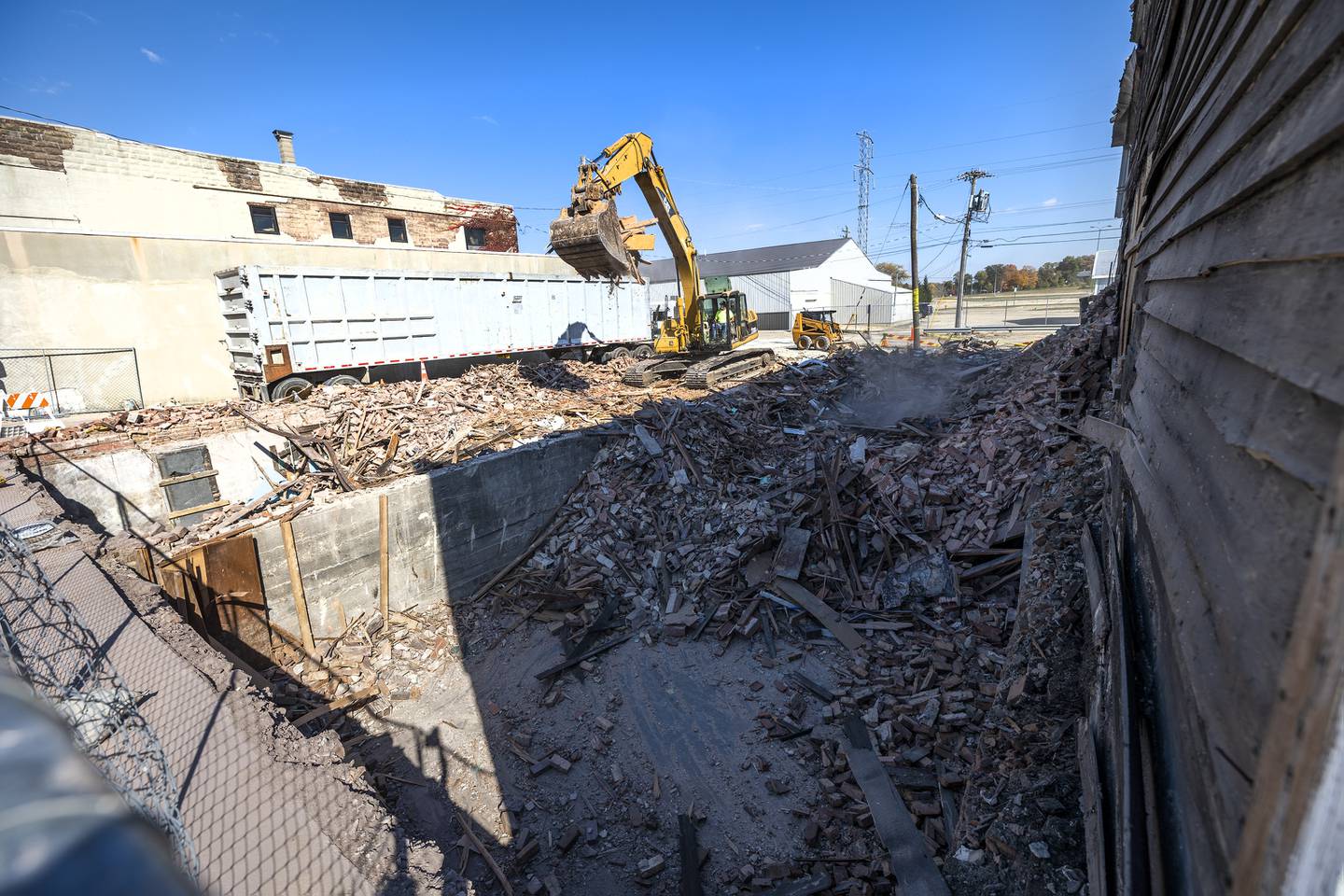 Patrick Burke of Burke Excavating works to clean up a downtown Rock Falls building Tuesday, Oct. 24, 2023.