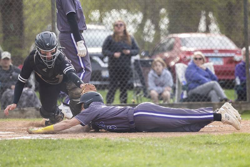 Dixon’s Easton Roux steals home with a great slide past Rock Falls’ Cadon Schulz  Monday, April 22, 2024 in Dixon.