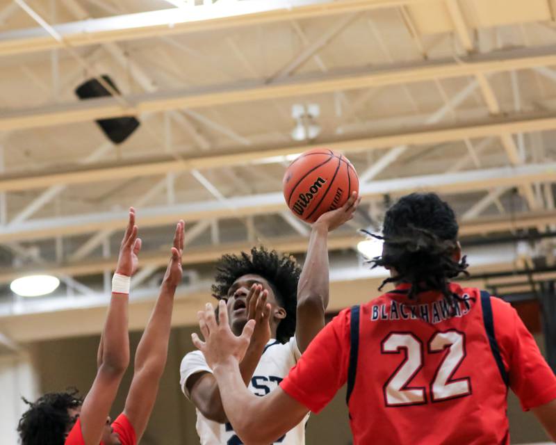 Oswego East's Javion Starwood (22) puts up a shot during Class 4A Lockport Regional final game between West Aurora at Oswego East.  Feb 24, 2023.