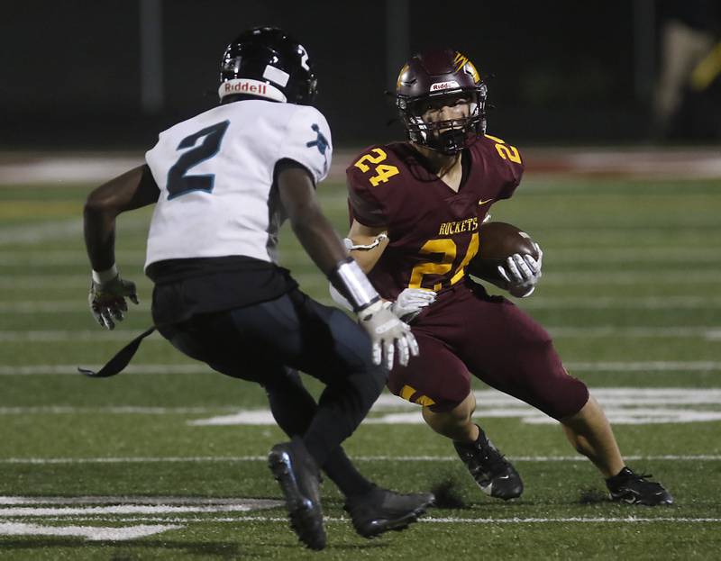 Richmond-Burton's Hunter Carley cuts back assigns the pursuit of Woodstock North's Emmanuel Fadahunsi during a Kishwaukee River Conference football game on Friday, Oct. 11, 2024, at Richmond-Burton High School.