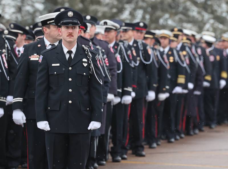 Firefighters from all around the area wait Saturday, Jan. 6, 2024, to file in to the visitation for Sycamore firefighter/paramedic Bradley Belanger at the Sycamore Park District Community Center. Belanger, 45, who worked with the Sycamore Fire Department for more than two decades, died Friday, Dec. 22, after a yearlong battle with cancer.