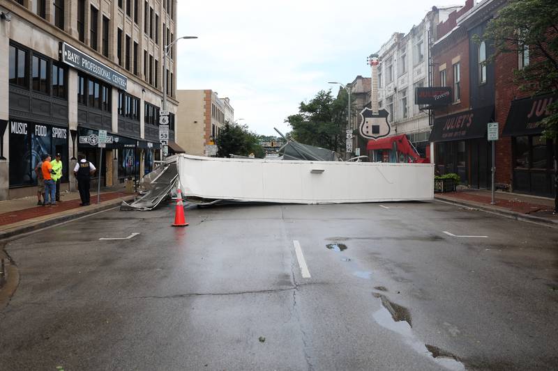 A large section of a roof blocks off East Cass Street after a storm blew through Joliet Sunday morning, July 14, 2024.