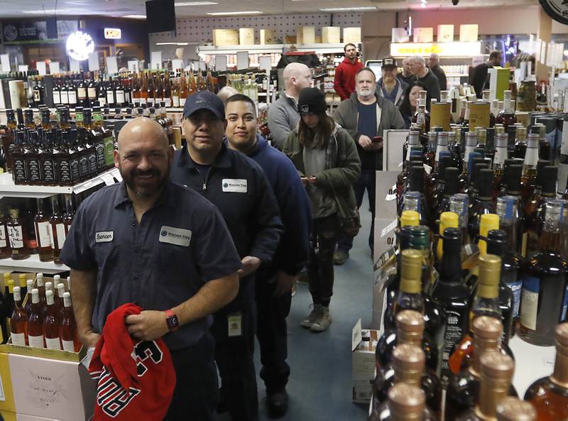 Robert Spencer holds a Pippen jersey as he waits to have retired Chicago Bulls star Scottie Pippen sign a bottle of his Digits bourbon Thursday, Feb. 9, 2023, at The International House of Wine and Cheese, at 11302 Route 12, in Richmond.