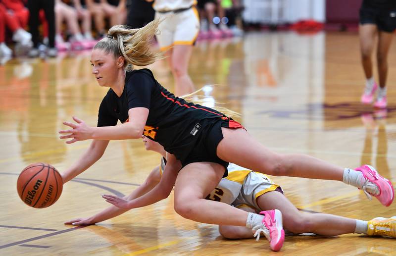 Batavia's Kylee Gehrt tries to maintain control of the ball as she trips over a Loyola player who fell in her path during a Coach Kipp Hoopsfest game on Jan. 13, 2024 at Montini Catholic High School in Lombard.