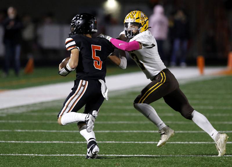 Jacobs' Owen Hoffman tries to tackle McHenry's Dayton Warren during a Fox Valley Conference football game on Friday, Oct. 18, 2024, at McKracken Field in McHenry.