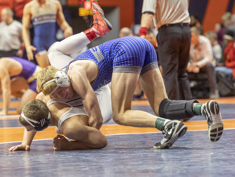 Sterling Newman Central’s Daniel Kelly takes down Hoopston’s Ayden Larkin in the 157 pound 1A fifth place match Saturday, Feb. 17, 2024 at the IHSA state wrestling finals at the State Farm Center in Champaign.