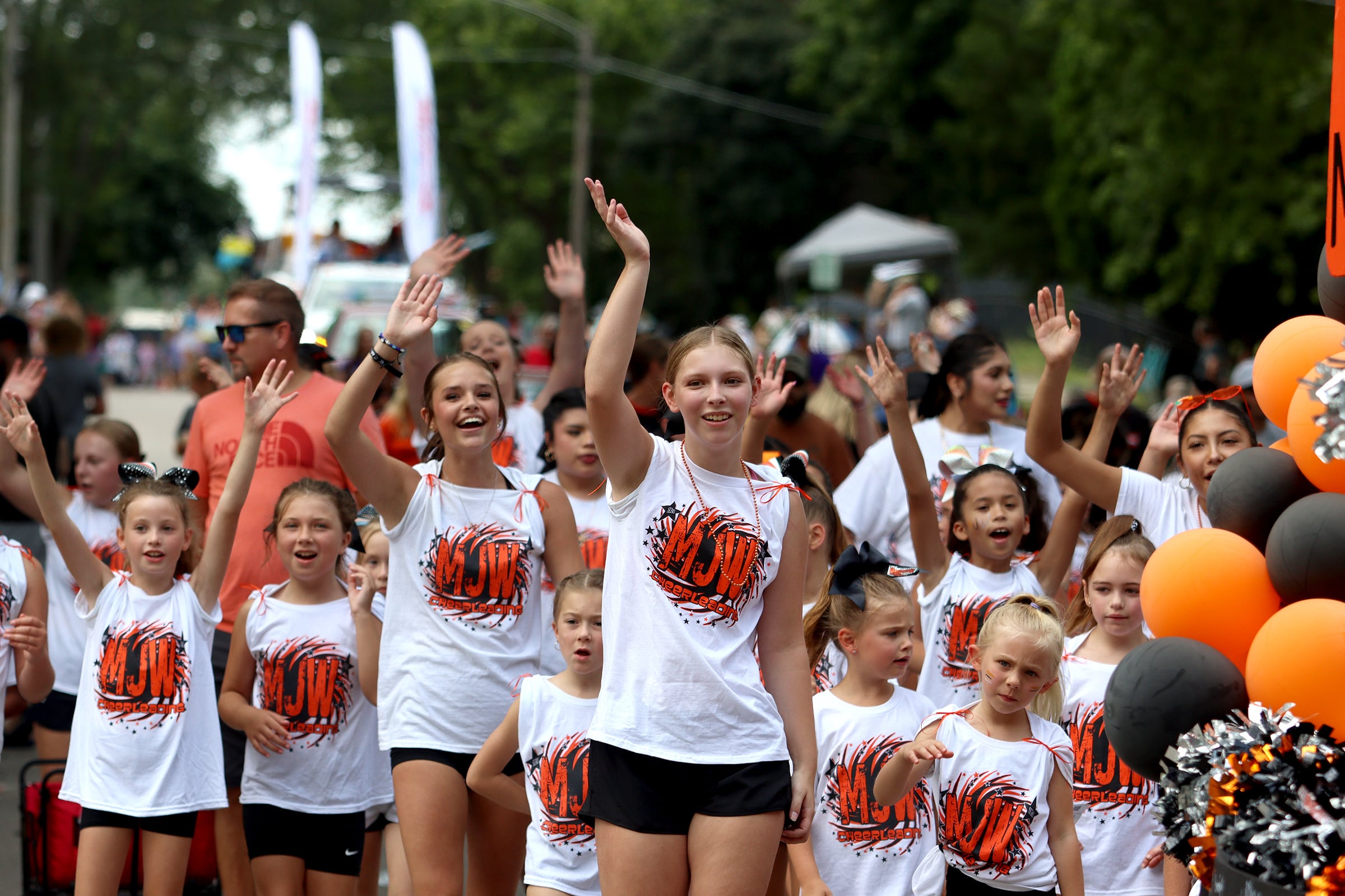 The McHenry Junior Warriors cheer team marches as part of the Fiesta Days parade along Main Street in McHenry Sunday.