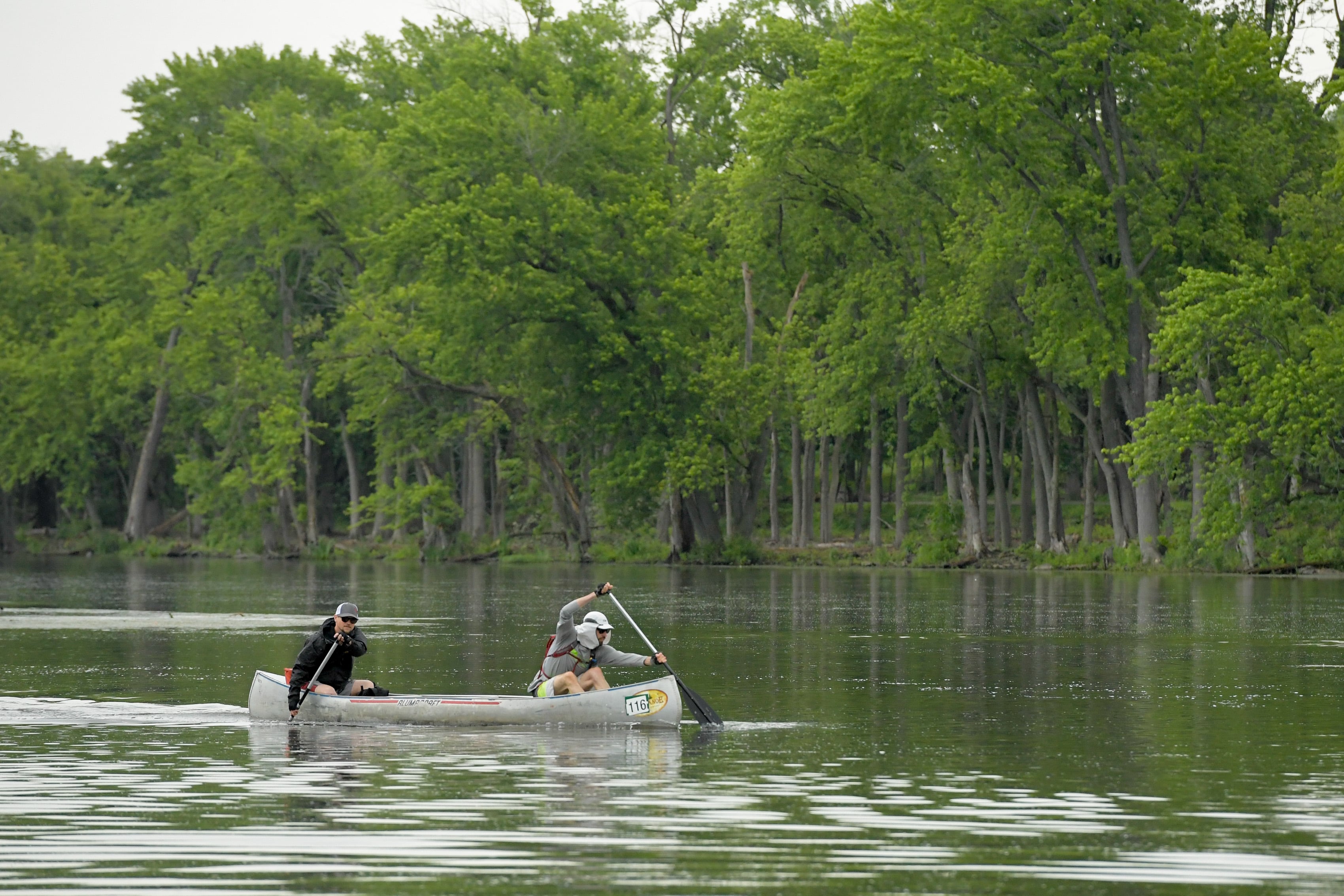 Canoeist paddle down the Fox River in Geneva during the annual Mid-American Canoe & Kayak Race on Saturday, June 1, 2024.