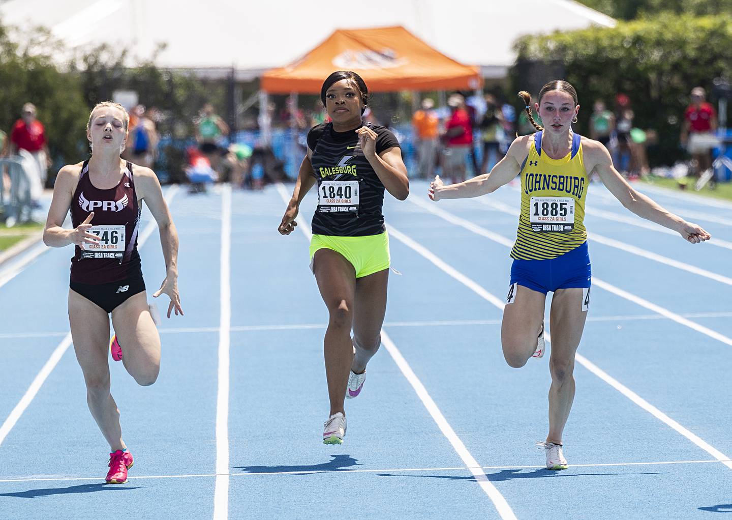 Prairie Ridge’s Katherin Jewell (left), Galesburg’s Syriah Boyd and Johnsburg’s Caitlyn Casella head for the finish in the 2A 100 dash Saturday, May 18, 2024 at the IHSA girls state track meet in Charleston.