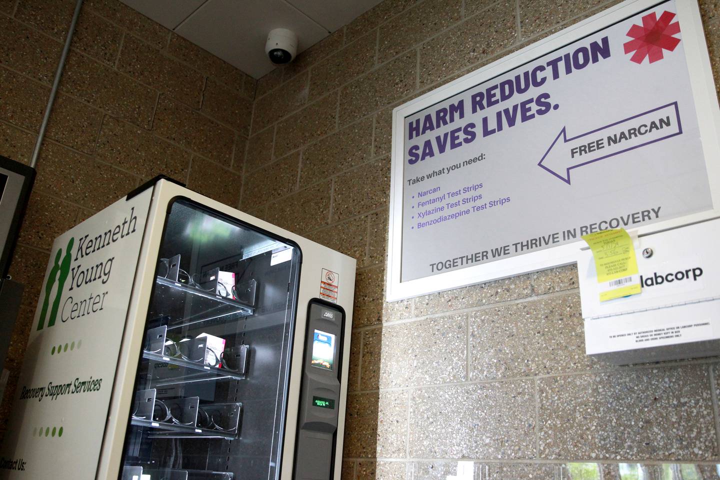 Daryl Pass, manager of Recovery Support Services for the Kenneth Young Center, fills the free narcan vending machine in the lobby of the Kane County Sheriff’s office in St. Charles. The center gets narcan free from the state overdose prevention program.