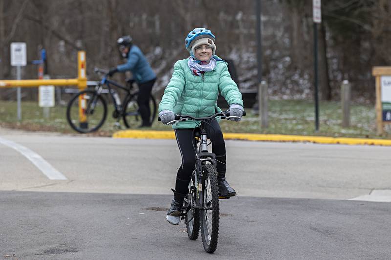 Teagan Moore, 12, is all smiles as she nears the end of her first New Year's Day bike ride Monday, Jan. 1, 2024. Afterwards the group had lunch together at a local establishment.