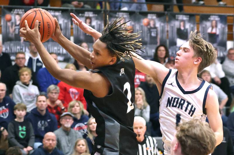 Kaneland's Isaiah Gipson grabs a rebound in front of Belvidere North's Braeden Brown Wednesday, Feb. 28, 2024, during their Class 3A sectional semifinal game at Kaneland High School in Maple Park.