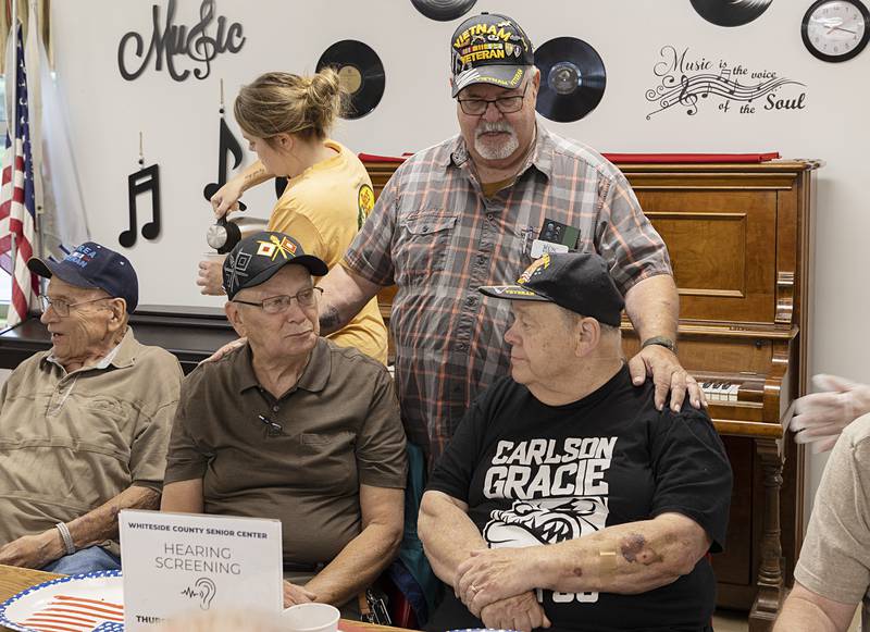 Butch Hannan (standing), greets Philip Szewczyk (left) and Jim Zeffield on Thursday, July 11, 2024, at the monthly breakfast. Hannon, along with Whiteside County Senior Center Director Emily Hammer and Beacon of Hope Hospice Care Consultant Peg Johnson have worked together to make this gathering a success.