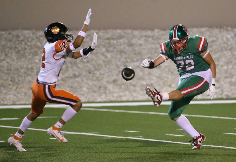 L-P punter Ricardo Santiago gets the punt off as United Township's Jesus Guzman-Keel defends on Friday, Aug. 30, 2024 at Howard Fellows Stadium.