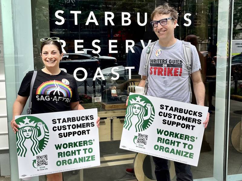 Courtney Rioux and Brett Neveu, union members of SAG-AFTRA and WGA, respectively, at a rally in Chicago on Aug. 9, 2023.