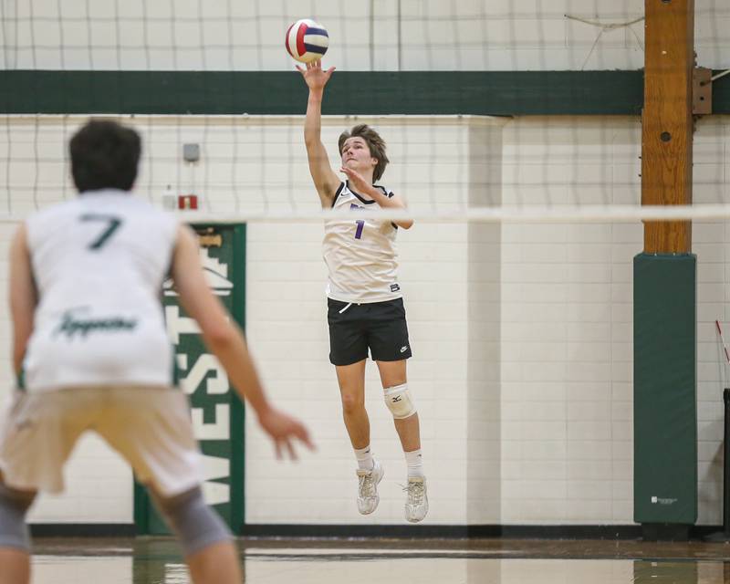 Downers Grove North's Lincoln Geist (1) serves during volleyball match between Downers Grove North at Glenbard West.  April 2, 2024.
