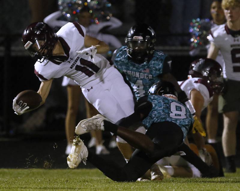 Marengo's Alten Bergbreiter fights from extra yards as he is tackled by Woodstock North's Sean Mitchell (center) and Maxwell Dennison (right) during a Kishwaukee River Conference football game on Friday, Sept. 13, 2024, at Woodstock North High School.