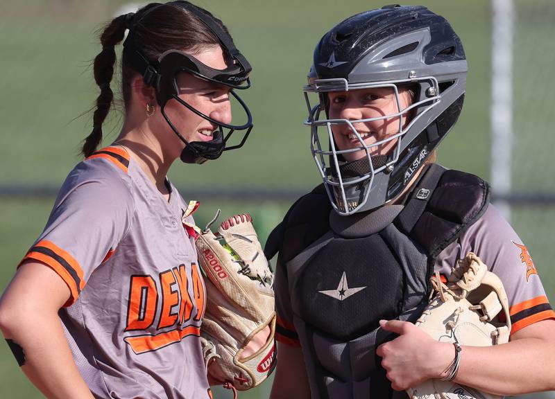 DeKalb pitcher Ayla Baty-Gould talks to battery-mate Madison Hallaron during their Class 4A regional semifinal game against Rockford Auburn Wednesday, May 22, 2024, at Hampshire High School.