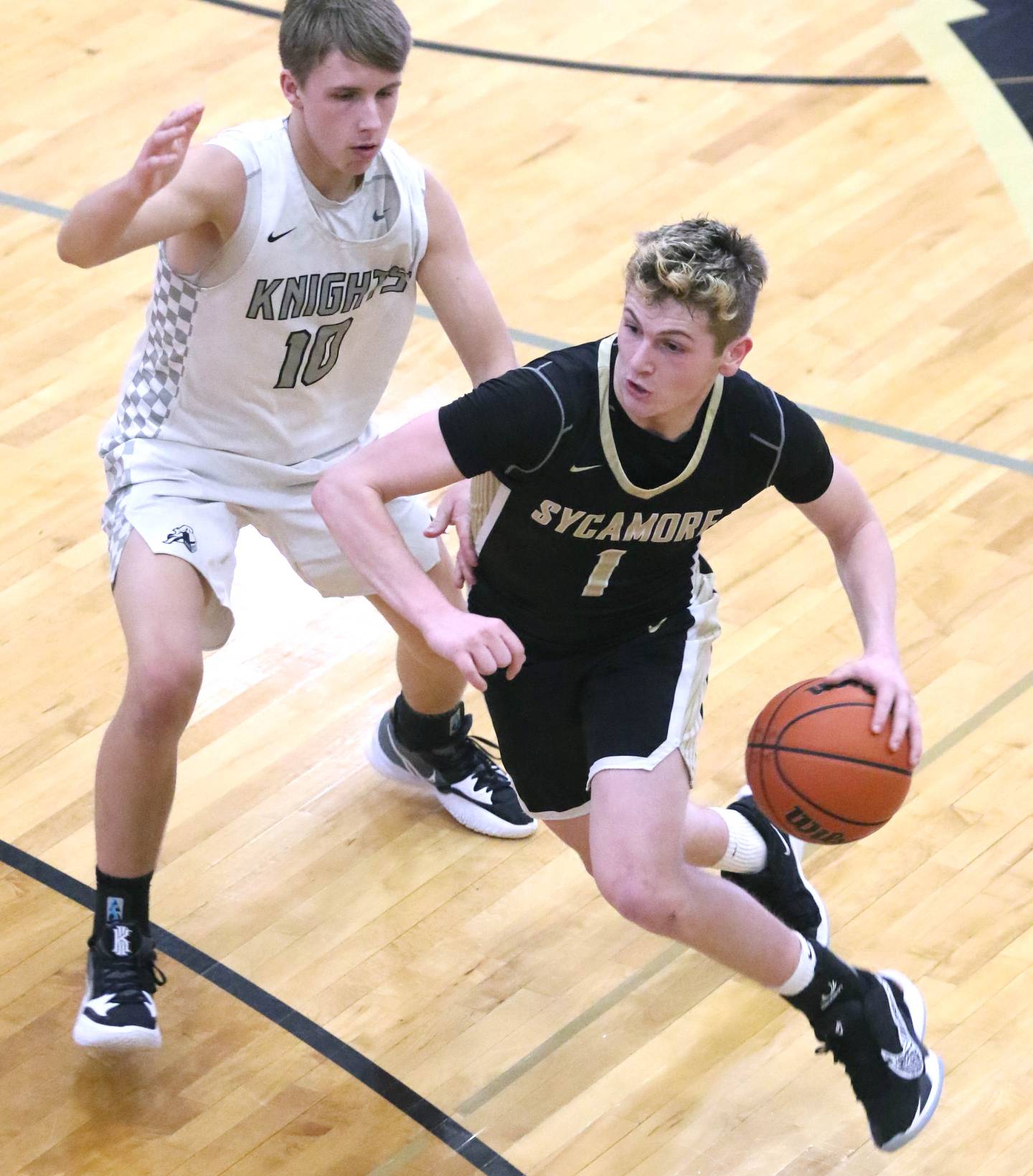 Sycamore's Brody Armstrong goes by Kaneland's Troyer Carlson during their Class 3A regional game Tuesday, Feb. 23, 2022, at Sycamore High School.