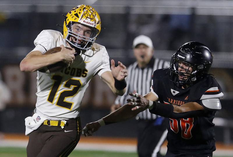 Jacobs' Connor Goehring runs away from McHenry's Elijah Guardyak during a Fox Valley Conference football game on Friday, Oct. 18, 2024, at McKracken Field in McHenry.