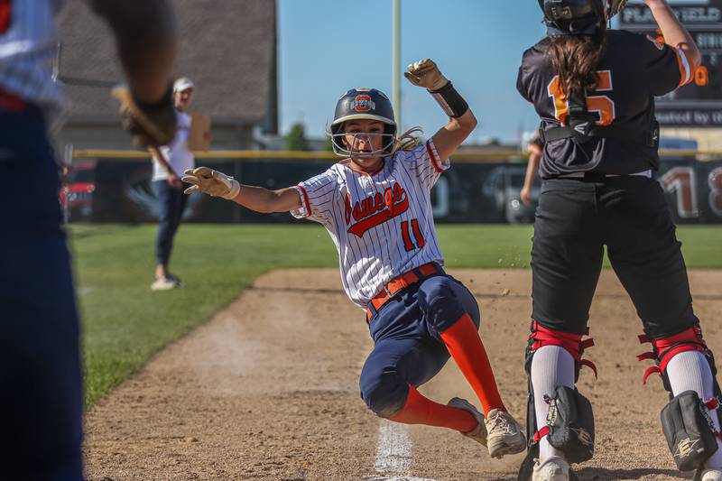 Oswego's Kaylee LaChappell (11) slides safely into home during Class 4A Plainfield North Sectional semifinal softball game between Wheaton-Warrenville South at Oswego. May 29th, 2024.