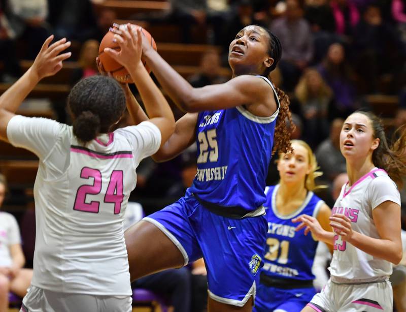 Lyons Township's Nora Ezike (25) takes the ball to the basket during a game against Downers Grove North on Jan. 30, 2024 at Downers Grove North High School in Downers Grove .