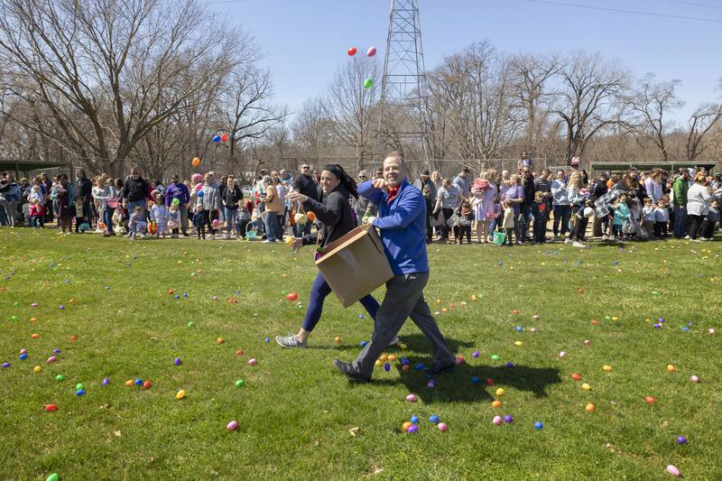 Dixon Park District director Duane Long gets help firing off some more eggs at the start of the 0-4 age egg hunt Saturday, April 8, 2023.