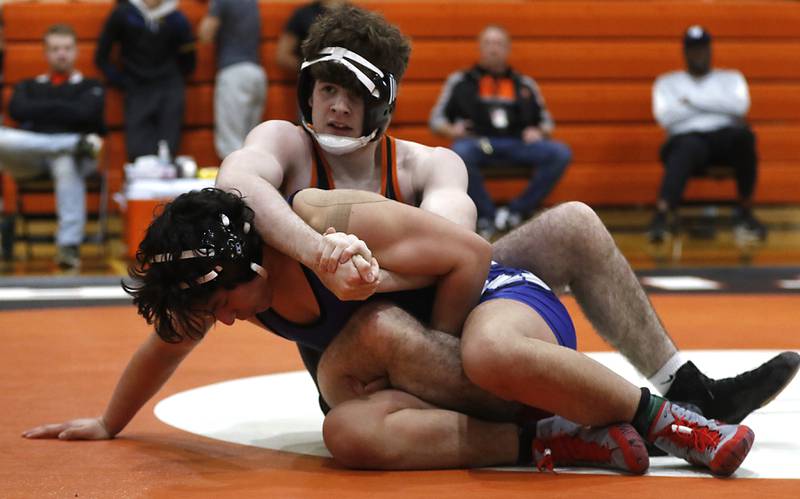 Crystal Lake Central’s Tyler Porter tries to control Burlington Central’s Johnah Chavez  during the 165-pound championship match of a the IHSA 2A Crystal Lake Central Wrestling Regional on Saturday, Feb. 3, 2024, at Crystal Lake Central High School.