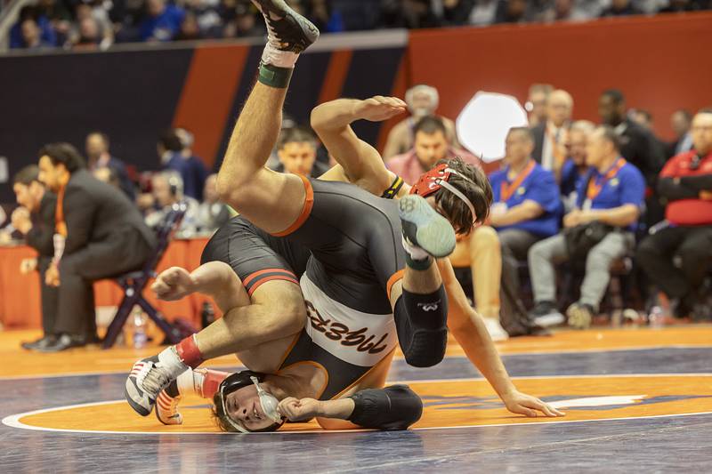 Crystal Lake South’s Cayden Parks (below) and Rock Island’s Andrew Marquez face off in the 2A 190 pound championship match Saturday, Feb. 17, 2024 at the IHSA state wrestling finals at the State Farm Center in Champaign.