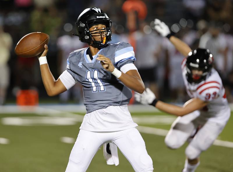 Willowbrook's Jabonise Reed (11) drops back to throw during the varsity football game between Glenbard East and Willowbrook high schools on Friday, Sep. 30, 2024 in Villa Park.