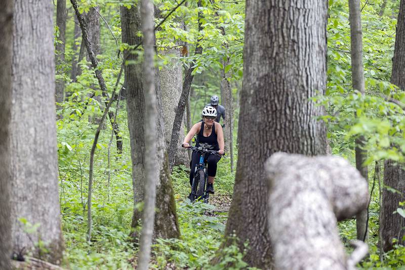 Veronica Sarver of Dixon comes out of the woods near the end of her ride Saturday, May 13, 2023 at Lowell Park in Dixon. Sarver, her husband Cory and her son Channing all participated in Saturday’s Rock River Madness.