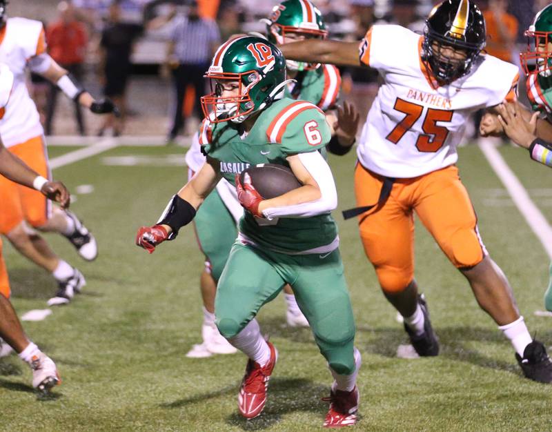 L-P's Adrian Arzola runs the ball past United Township's Riley King on Friday, Aug. 30, 2024 at Howard Fellows Stadium.