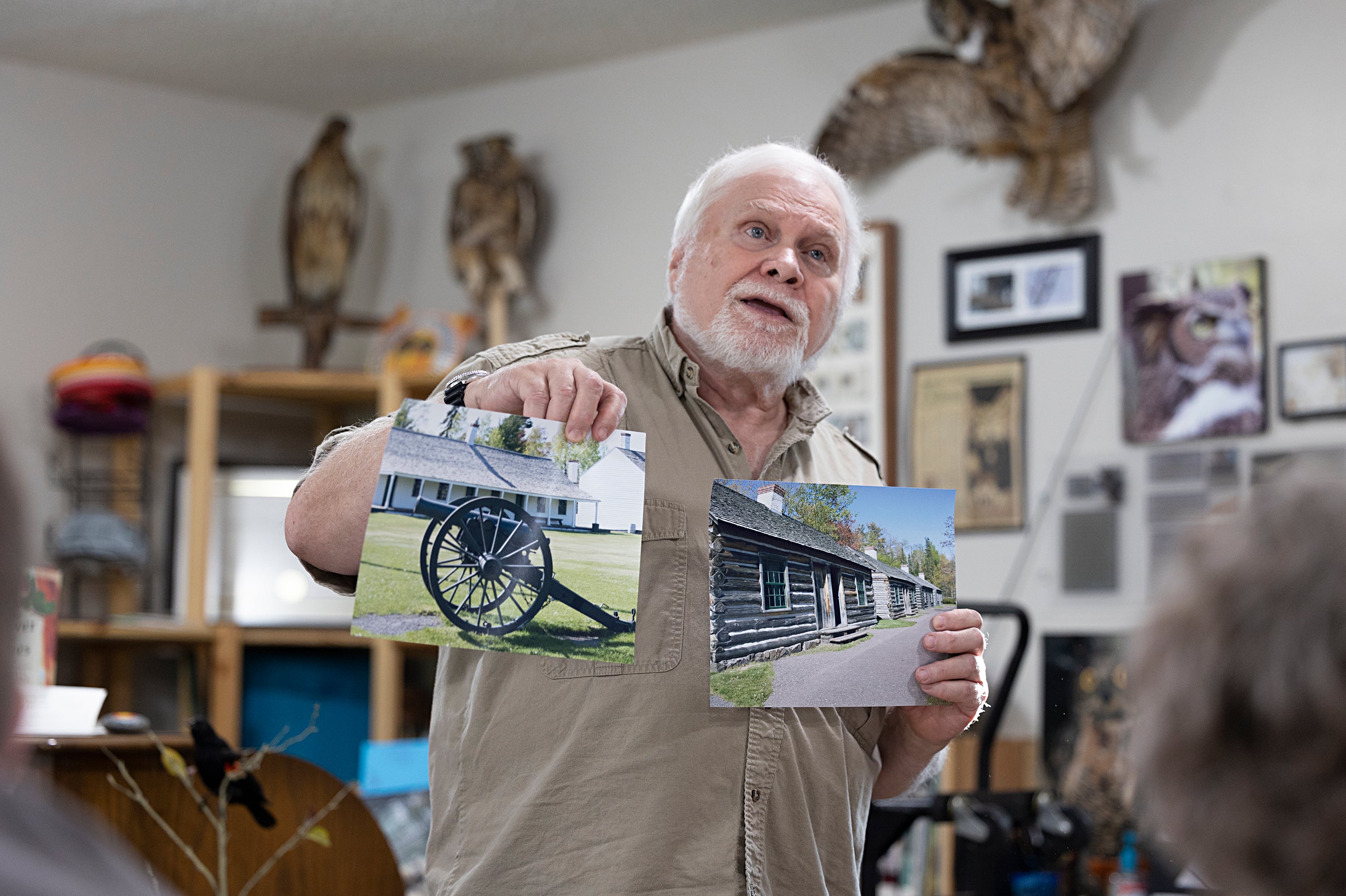 Retired SVCC professor Ralph Pifer shows off a couple of his photos of the Upper Peninsula during a program in Lowell Park. Pifer talked about the diverse and interesting area that is the U.P.