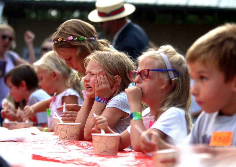 Lillian Nehring, 6, of Crystal Lake, experiences brain freeze Friday, Aug. 18, 2023, during an ice cream-eating contest as part of Julie Ann’s first-ever Ice Cream Fest at Crystal Lake’s Main Beach.