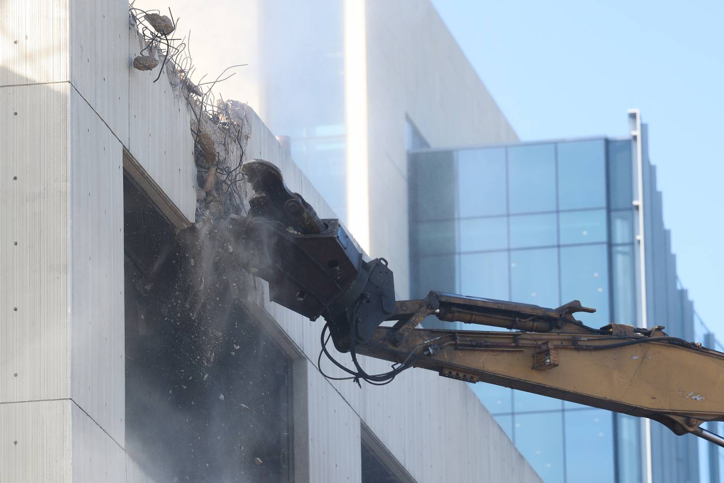 The new Will County Courthouse sits in the background as a claw begin working on the external demolition of the old Will County Courthouse on Friday, Feb. 9th 2024 in Joliet.