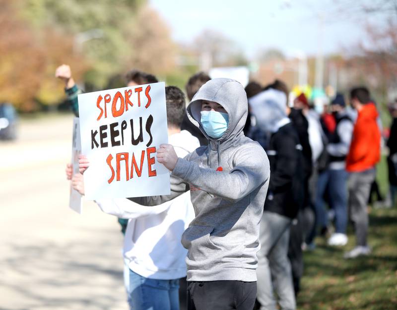 St. Charles East High School student athlete Blaine Hansen, a senior, joins other athletes outside the school on Oct. 30 in response to the postponement of the winter sports seasons by Gov. JB Pritzker and the Illinois High School Association.