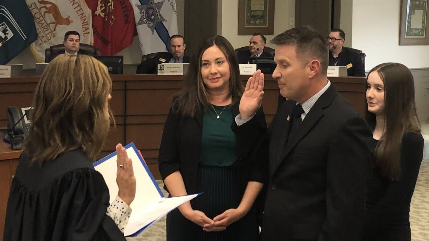 Mark M. Foulkes alongside his family Monday May 1, 2023, being sworn in as the new Ward 1 Alderperson by the honorable Judge Elizabeth Flood at St Charles City Council meeting at 2 Main St.